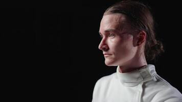 Handsome Young Fencer Putting Protective Helmet On Head And Waiting For Start Of Sparring video
