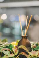 Reed diffuser. Aroma scent reed diffuser bottle is used as air freshener on the table. photo