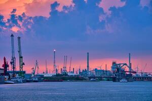 Port of Antwerp with harbor cranes in twilight photo