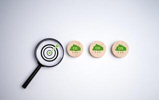 Net zero by 2050, Circle plank with green cloud icon and dartboard focus magnifying glass on white background, Net zero green house gas emissions target, Climate neutral long term strategy. photo