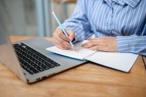 A cropped image of a woman lecturing an online meeting in a book, working remotely from a cafe. photo