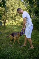 man playing with dog, tug toy, chew toy photo