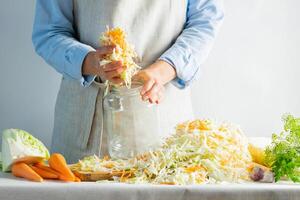 The preparation process fermentation preservation Sauerkraut on a light background. Natural rustic style. Canned food photo