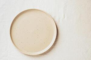 Empty ceramic shape plate for food on the table top view. Copy space template for your text photo