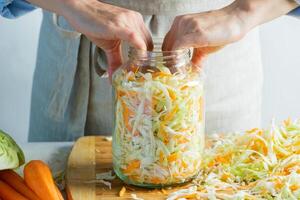 The preparation process fermentation preservation Sauerkraut on a light background. Natural rustic style. Canned food photo