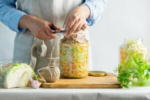 The preparation process fermentation preservation Sauerkraut on a light background. Natural rustic style. Canned food photo
