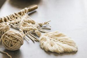 Handmade knitting macrame. Boho lifestyle. Hobby hobby concept. Selective focus. Horizontal frame photo