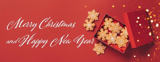 Christmas gingerbread cookies red box on a red festive background with sparkles and serpentine photo