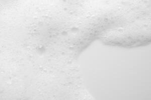 Abstract white soap foam bubbles texture on white background photo