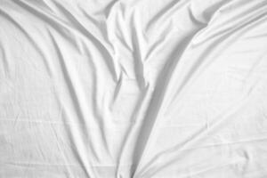 Abstract white wrinkled bedding sheet fabric texture background photo