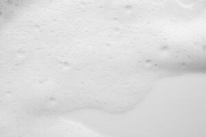 Abstract white soap foam bubbles texture on white background photo