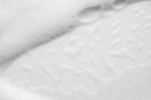 Abstract white soap foam bubbles texture on white background photo