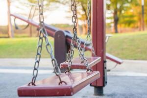 Empty chain swing in the playground photo