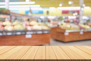 Empty wood table top with supermarket blurred background for product display photo