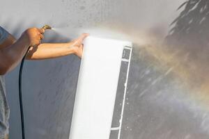 air conditioning cleaning service with water spray photo