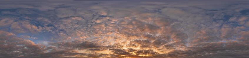 Golden sunset sky panorama Seamless spherical equirectangular 360-degree view with beautiful Stratocumulus clouds setting sun - for use in 3D graphics as a sky dome or post-processing of drone images photo