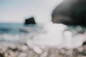 Abstract nature summer ocean sunset sea background. Small waves on water surface in motion blur with bokeh lights from sunrise. Holiday, vacation and recreational background concept. photo