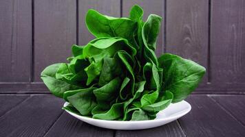 A bunch of fresh aromatic spinach greens on a beautiful background photo