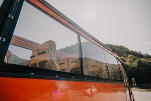 Red Bus Window with Empty Seats photo