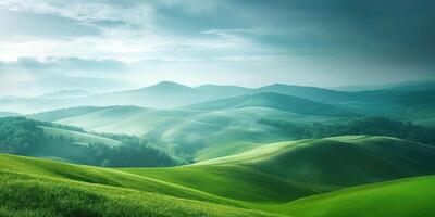 Scenic view of rolling green hills under cloudy sky, serene landscape with misty mountains in background, tranquil nature concept photo