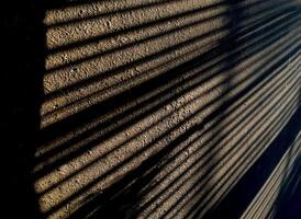 Abstract geometric from a shadow pattern on the asphalt street, long lines in monochrome tones. Copy space for text photo