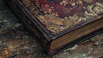 The cover of the book is a deep burgundy color with faded gold lettering and designs. As the book is od the spine reveals a delicate floral pattern hinting at the beauty that lies withi photo