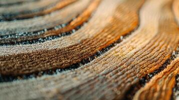 The closeup image of a handmade rug reveals the meticulous technique used to create the subtle variation of tone and texture in a beautiful ombre effect giving this rug a unique an photo