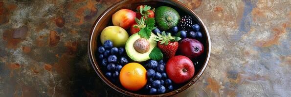 A bowl filled with assorted fruits and vegetables each containing a small amount of avocado oil as a symbol of the numerous nutritional benefits it provides for skin and hair health photo
