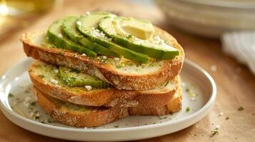 A stack of freshlybaked whole wheat toast lightly coated with avocado oil and topped with sliced avocado and a sprinkle of salt for a simple and satisfying breakfast photo