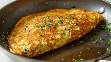 A fluffy omelette cooked in a skillet greased with avocado oil photo