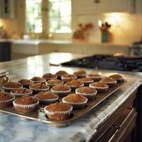 A kitchen counter lined with trays of buckwheat muffins eagerly awaiting their turn in the oven photo
