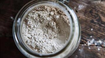 A jar of buckwheat flour with a delicate layer of dust on top a reminder that this humble grain has the power to nourish and delight in so many ways photo