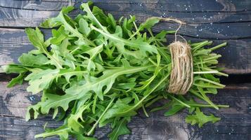 A bundle of fresh arugula leaves their delicate s visible and creating an intricate pattern photo