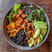 A colorful Buddha bowl filled with a variety of plantbased proteins such as chickpeas black beans and tempeh on a bed of mixed greens. This bowl is not only visually appealing but als photo