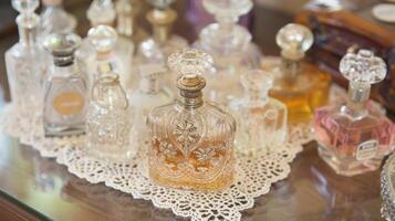 A charming display of antique perfume bottles each with its own intricate design sitting atop a dainty lace doily photo