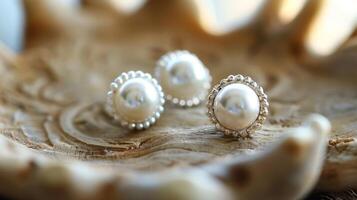 A pair of pearl stud earrings with a twist featuring a dainty lace design around the edges adding a touch of whimsy to a classic accessory photo