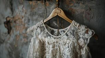 A vintage lace dress hanging on a brass hanger its delicate fabric and vintage texture adding a touch of sophistication to any wardrobe photo