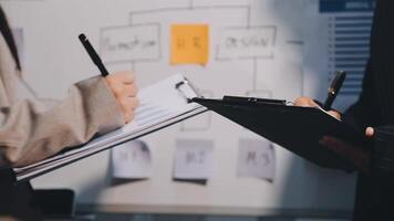 Two executive discussing company growth project success financial statistics, Partner meeting professional investor working start up project for both company with document, laptop and digital tablet. video