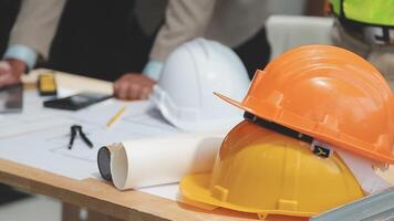 Teamwork men in construction site, Two civil engineer or professional foreman in safety helmet hard hat using blueprint in digital tablet working while standing at industrial factory, teamwork concept video