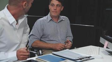 Diverse managers traders analysts discussing financial growth market at desk with laptop with graphs on screen using tablet device. Investors brokers analysing indexes online cryptocurrency stock. video