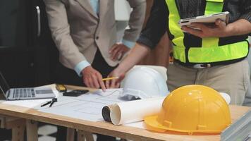 Teamwork men in construction site, Two civil engineer or professional foreman in safety helmet hard hat using blueprint in digital tablet working while standing at industrial factory, teamwork concept video