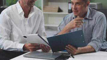 Diverse managers traders analysts discussing financial growth market at desk with laptop with graphs on screen using tablet device. Investors brokers analysing indexes online cryptocurrency stock. video