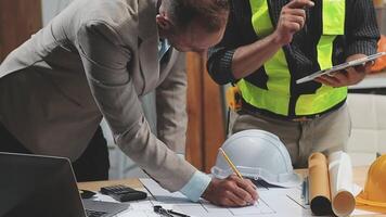 Teamwork men in construction site, Two civil engineer or professional foreman in safety helmet hard hat using blueprint in digital tablet working while standing at industrial factory, teamwork concept video