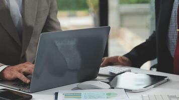 Diverse managers traders analysts discussing financial growth market at desk with laptop with graphs on screen using tablet device. Investors brokers analysing indexes online cryptocurrency stock. video