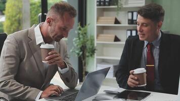 Diverse managers traders analysts discussing financial growth market at desk with laptop with graphs on screen using tablet device. Investors brokers analysing indexes online cryptocurrency stock. video