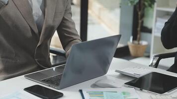Diverse managers traders analysts discussing financial growth market at desk with laptop with graphs on screen using tablet device. Investors brokers analysing indexes online cryptocurrency stock. video