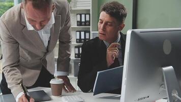 Diverse managers traders analysts discussing financial growth market at desk with laptop with graphs on screen using tablet device. Investors brokers analysing indexes online cryptocurrency stock. video