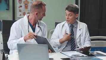 Doctors in office working on medical report video