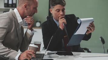 Diverse managers traders analysts discussing financial growth market at desk with laptop with graphs on screen using tablet device. Investors brokers analysing indexes online cryptocurrency stock. video
