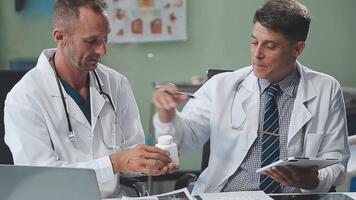 Doctors in office working on medical report video